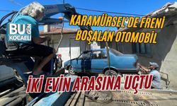KARAMÜRSEL'DE FRENİ BOŞALAN OTOMOBİL İKİ EVİN ARASINA UÇTU