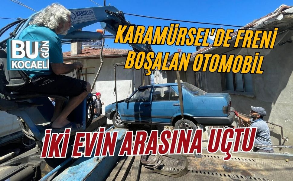 KARAMÜRSEL'DE FRENİ BOŞALAN OTOMOBİL İKİ EVİN ARASINA UÇTU